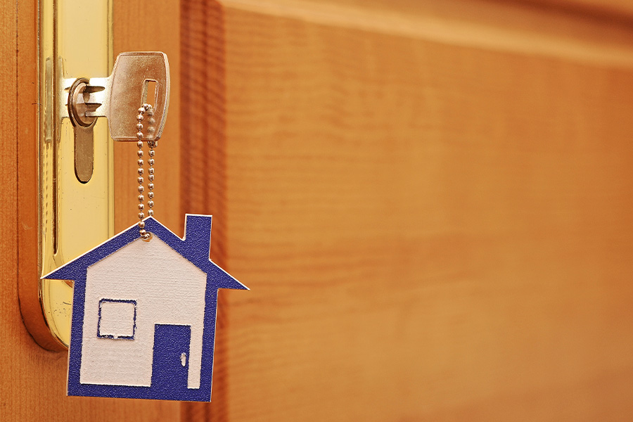 key in door lock with a house keychain